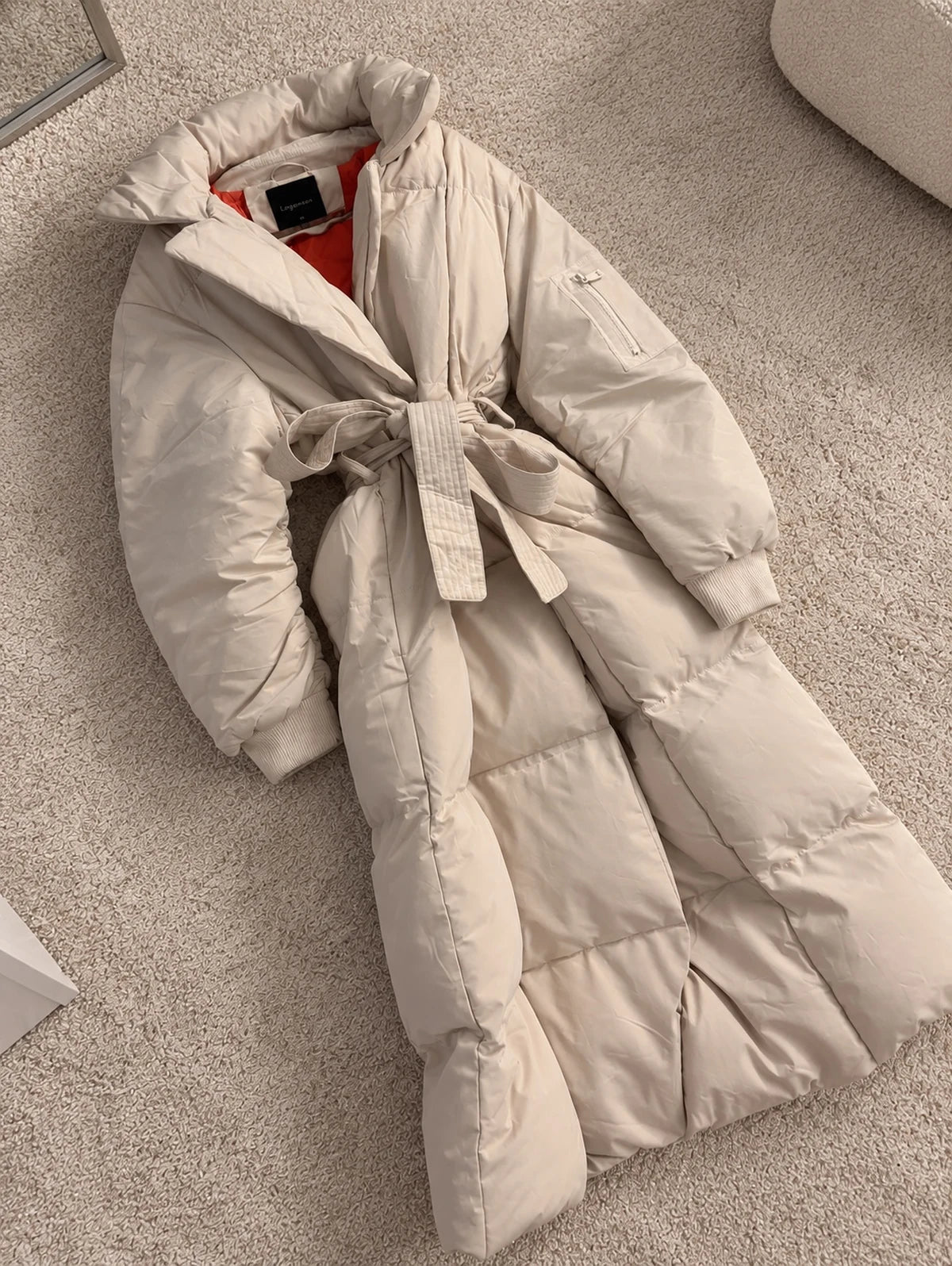 Cream belted longline puffer coat from the MALPELI autumn coats edit